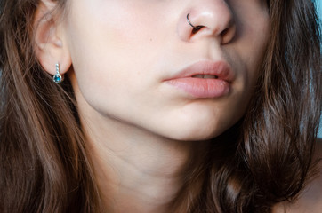  Beautiful young woman with pierced nose ring and bright make-up 