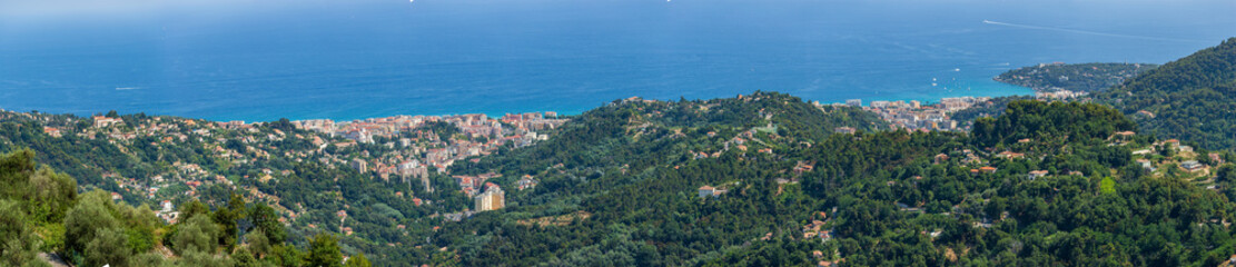 Fototapeta na wymiar Panoramic view of Menton and the surrounding hillside buildings in front of the A8 bridge road, as captured from Sainte Agnes