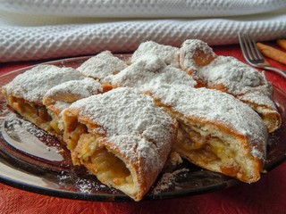 Homemade strudel with apples, banana and raisins, healthy food concept