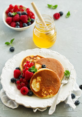 Breakfast - Cottage cheese pancakes,  curd fritters with raspberry, strawberry, blueberry.  Selective focu