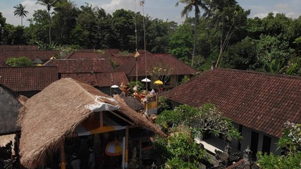 4K aerial view of traditional balinese houses. Flying over balinese village. Bali island.