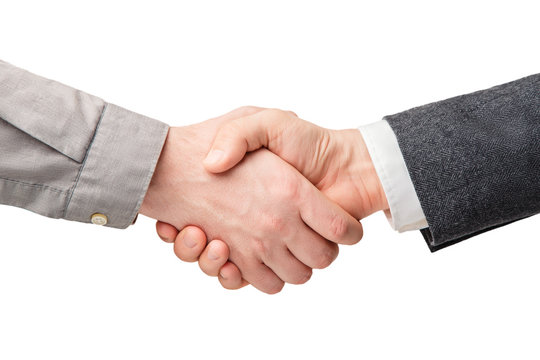 Business handshake and business people concepts. Two men shaking hands isolated on white background. Close-up image of a firm handshake between two colleagues