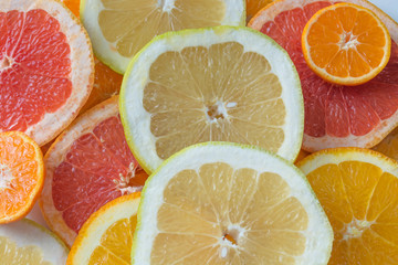 Fresh citrus fruits background - orange, grapefruit, mandarin, pomelo. Copy space. Food frame, vitamin concept