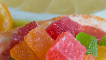 Candied fruit and fresh citrus fruits background. Copy space. Food frame, vitamin concept