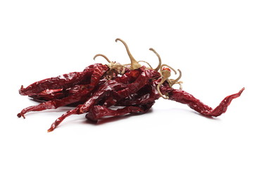 Fototapeta premium Dry red, spicy peppers, pile isolated on white background