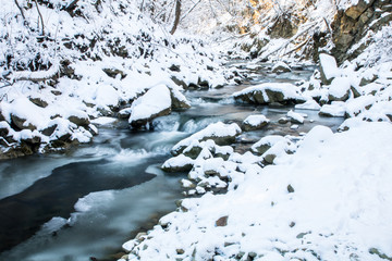 scenic blue color smooth frozen mountain creek