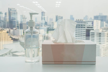 alcohol gel bottle with tissue paper box in office for cleaning and sanitary