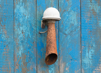 Alarm horn hanging on a blue wall