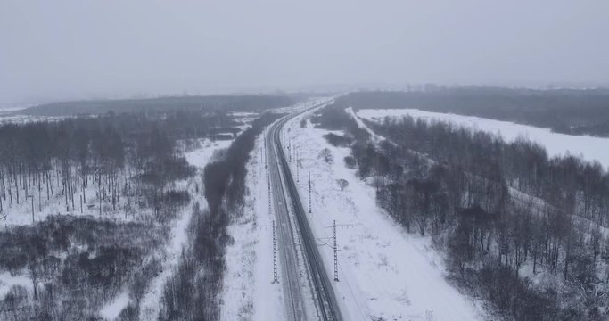 Empty frozen Trans Siberian Railway in winter day time in central Russia - Aerial Top Dawn View