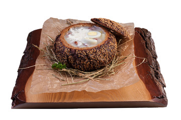 Zurek. Traditional Polish soup with smoked meats in bread