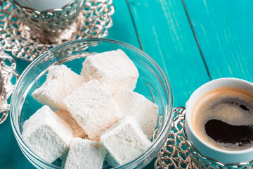 Traditional turkish coffee and turkish delight on wooden background.