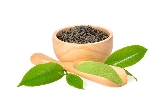 Green tea powder and dried leaves on white background