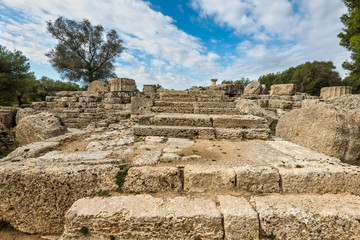Fototapeta na wymiar Ancient ruins of a temple at Olympia, Greece