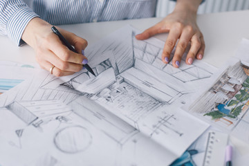 Architect interior's hands drawing home illustration project, renovation concept