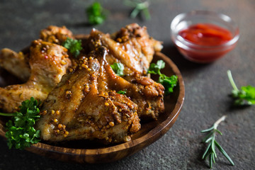 Baked chicken wings with fresh herbs and ketchup