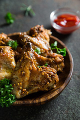 Baked chicken wings with fresh herbs and ketchup