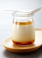 Delicious creamy pudding on a white background