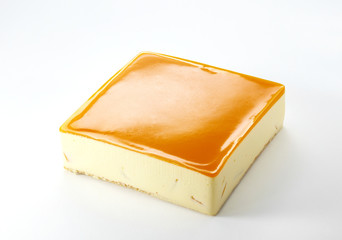 Delicious mango cheesecake on a white background