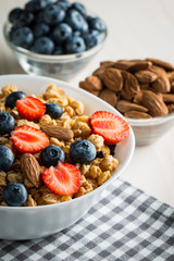 Healthy breakfast concept with oat flakes and fresh berries on rustic background. Food made of granola and muesli. Healthy banana smoothie with blackberries, honey and milk.
