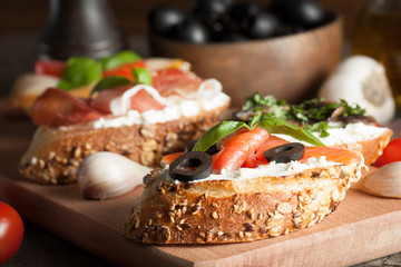Italian tomato and cheese bruschetta. Tapas, antipasti with chopped vegetables, herbs and oil on grilled ciabatta and baguette bread.