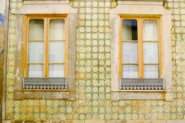 Yellow facade with typical azulejos, Portugal.