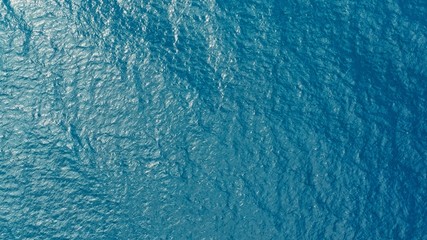 aerial drone image of the deep blue clear sea ocean water with small waves rolling