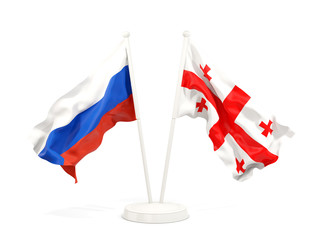 Two waving flags of Russia and georgia