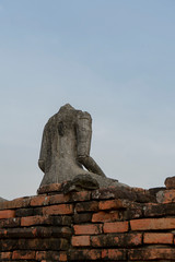 Fototapeta na wymiar Old Buddha statue no head with sky background