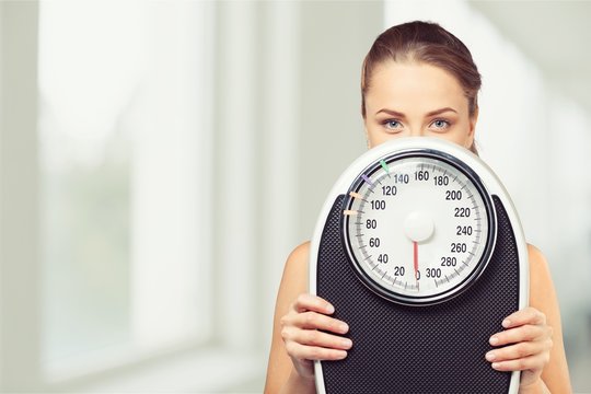 Young Woman With Scales Isolated