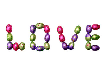 Chocolate Easter eggs in colorful foil isolated on white background. The word LOVE made from candies isolated on white background. The word love from chocolate eggs on white background.