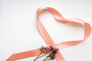 Pink ribbon heart with flowers. Flat lay, top view. Valentines and 8 March Mother Womens Day concept