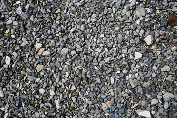 Abstract background from white and brown gravel stones on the ground