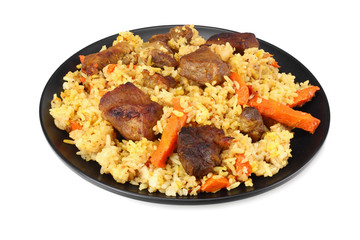 pilaf with meat on black plate isolated on white background
