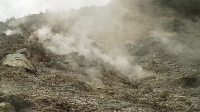 plateau with geothermal volcanic activity, geysers. volcanic landscape Dieng Plateau, Indonesia. Famous tourist destination of Sikidang Crater it still generates thick sulfur fumes.