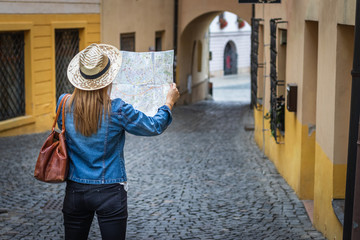 Woman tourist with map on the street. Travel in Europe. 