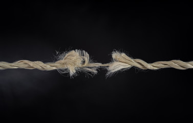 worn out rope break and black background