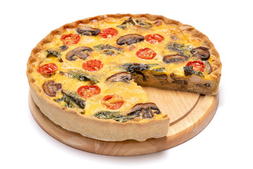 Baked homemade quiche pie on wooden cutting board