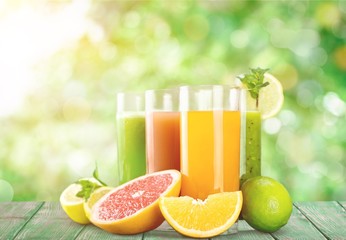 Tasty fruits and juice on wooden table
