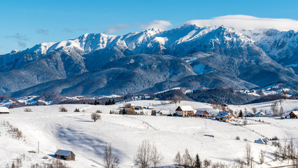 Brasov - Romania, Rucar - Bran snowy picturesque hills on a sunny cold December.