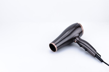 Brown glossy hair dryer on the white background with copy space