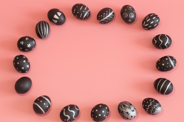 Easter eggs in black on a colored pink background
