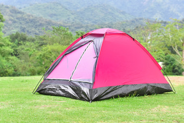 Pink color dome tent and mountain range landscapes in the background.