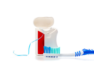 dental floss and toothbrush on an isolated background