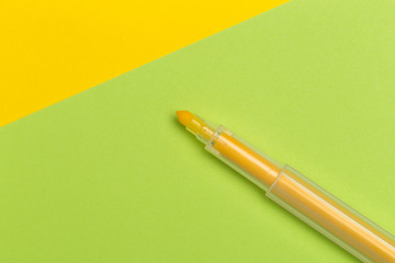 yellow marker  on colour yellow and green background.