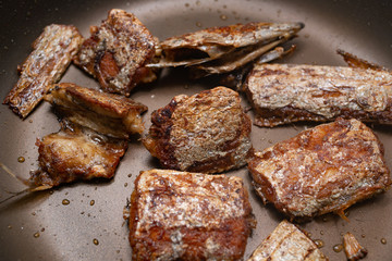cooking fried fish on a pan