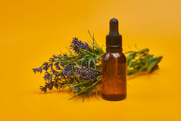 bottle of essential oil with lavender flowers