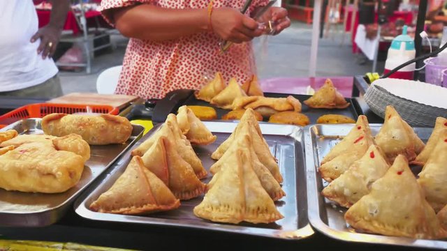Samosa at food market in Thailand. saleswoman packs for sale to buyer. 3840x2160