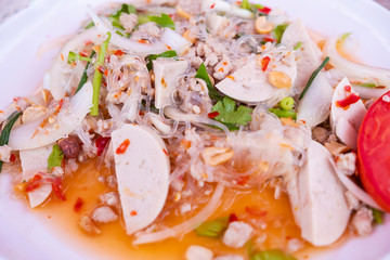Blurred for Background.Spicy Vietnamese Sausage Salad in white plate.There are mince, pork, tomato, chili, vermicelli.