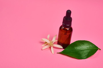 bottle of essential oil with flowers