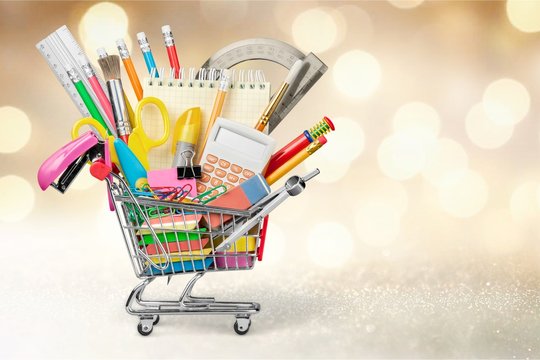 School stationery composition in shopping cart